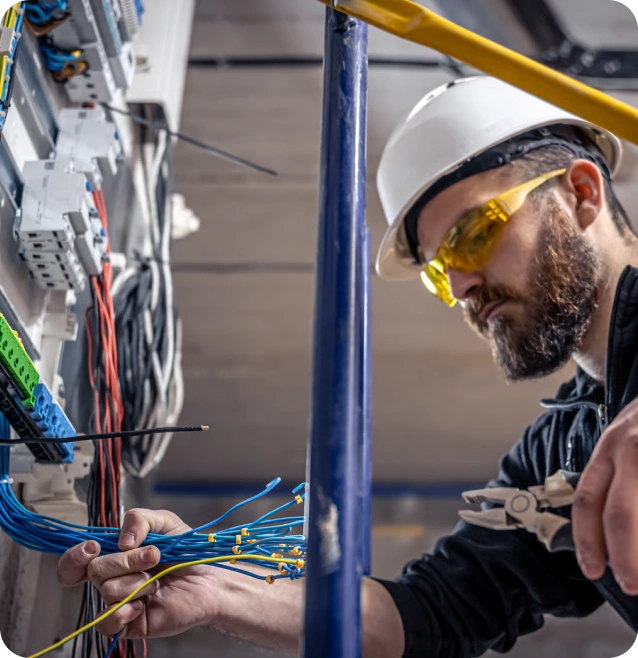 Certified master electrician in Dubai reviewing building blueprints