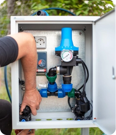 Plumber providing late-night emergency water pump repair to stop flooding.