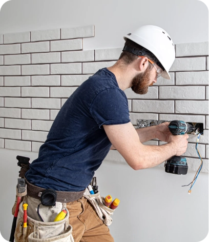 Experienced electrician in Dubai installing a ceiling fan in Sports City