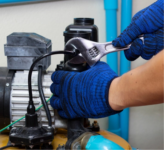Experienced plumber working to fix water pump wiring and electrical faults.