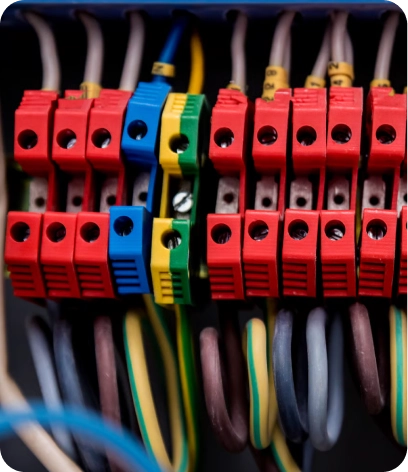 Professional electrician in Dubai using testing tools on a wall outlet